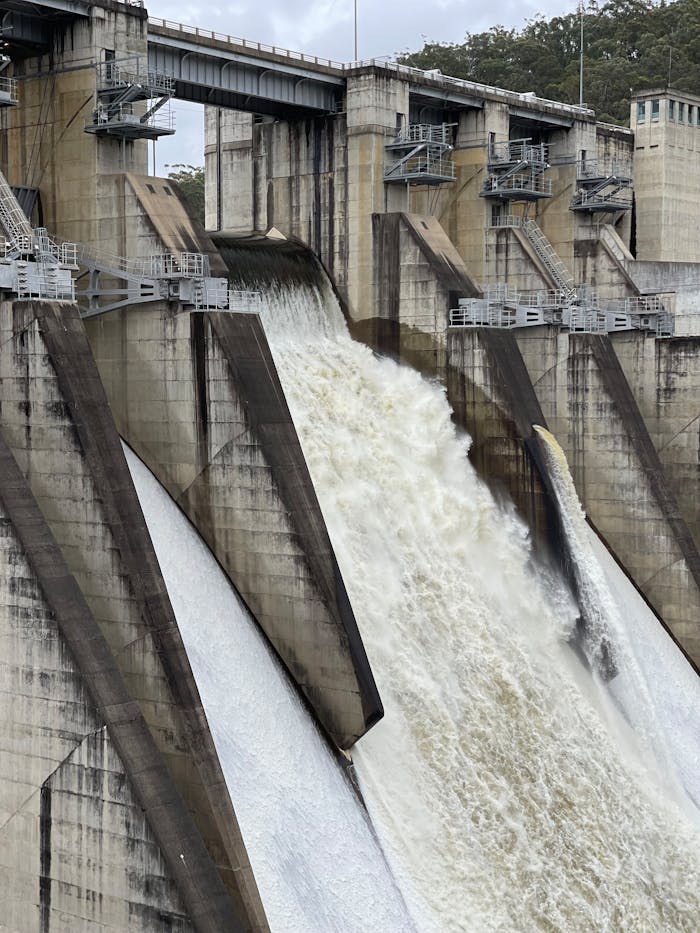 pexels-photo-10668591 Powerful water cascade over a large concrete dam showcasing hydroelectric power.